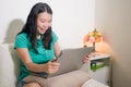 Home lifestyle portrait of young happy and beautiful Asian Chinese woman at home networking using laptop computer on bed smiling Royalty Free Stock Photo