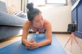 Home lifestyle portrait of young happy and beautiful Asian Japanese woman working out and training her body on yoga mat following Royalty Free Stock Photo