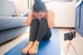 Home lifestyle portrait of young happy and beautiful Asian Korean woman working out and training her body on yoga mat following Royalty Free Stock Photo