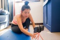 Home lifestyle portrait of young happy and beautiful Asian Korean woman working out and training her body on yoga mat following Royalty Free Stock Photo