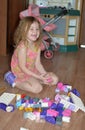 At home, a little girl plays construction kit. Royalty Free Stock Photo