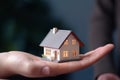 Home loan for new family symbolized by hand holding paper house model Royalty Free Stock Photo