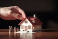 Home loan for new family symbolized by hand holding paper house model Royalty Free Stock Photo