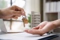 home loan officer gives the house keys to the client after signing a real estate contract with an approved mortgage application Royalty Free Stock Photo