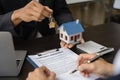 home loan officer gives the house keys to the client after signing a real estate contract with an approved mortgage application Royalty Free Stock Photo