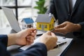 home loan officer sending house model to client after signing agreement contract real estate with approved mortgage application Royalty Free Stock Photo