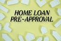 Home Loan Pre-Approval text with house models on yellow background Royalty Free Stock Photo