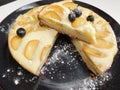 Home made apple cake in the black plate served on table Royalty Free Stock Photo