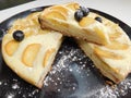 Home made apple cake in the black plate served on table Royalty Free Stock Photo