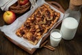 Home made apple pie on a tray, on a brown background.