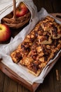 Home made apple pie on a tray, on a brown background.