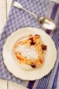 Home made cherry crumble with powdered sugar on a plate Royalty Free Stock Photo