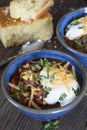 Home made chili with beans, cheese, sour cream, and cornbread.