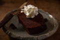 Home made chocolate cake or browny with cream on wooden table ,unhealthy eating