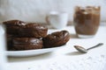 Home made chocolate muffins served on a rustic kitchen next to some cups with coffee and tea. Empty copy space. Royalty Free Stock Photo