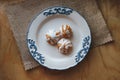 Home made choux cream on white plate. Over on wood table. Top view. with a white glaze. on wooden background Royalty Free Stock Photo