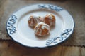 Home made choux cream on white plate. with a white glaze. Over on wood table. Top view. Royalty Free Stock Photo