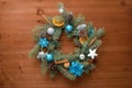 home made Christmas tree wreath made of fir branches on a wooden background with blue and silver balls in the colors of 2021 bull Royalty Free Stock Photo