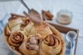 Cinnamon rolls with sugar frosting. With cinnamon sticks and spices, wooden background Royalty Free Stock Photo