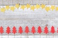 Home made decorations, golden stars and red Christmas trees on white wooden background. Retro style Royalty Free Stock Photo