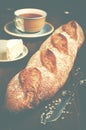 Home made fresh baguette, a plate with cheese and cup of tea on Royalty Free Stock Photo