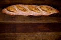 Home made fresh baguette on wooden table with copy space. Royalty Free Stock Photo