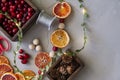 Home made garlad of natural materials - dry orange chips, berries, wood balls and cones,eco friendly, on wooden table with lights Royalty Free Stock Photo