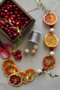 Home made garlad of natural materials - dry orange chips, berries, wood balls, eco friendly, on wooden table with lights Royalty Free Stock Photo