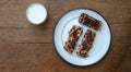 Home made healthy cereal bars.in kitchen with glass of milk  honey pot ,& drizzler Royalty Free Stock Photo