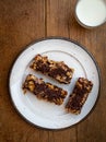 Home made healthy cereal bars.in kitchen with glass of milk  honey pot ,& drizzler Royalty Free Stock Photo