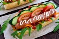 Home made hot dogs with vegetables, juicy sausage and arugula Royalty Free Stock Photo