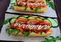 Home made hot dogs with vegetables, juicy sausage and arugula Royalty Free Stock Photo