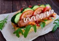 Home made hot dogs with vegetables, juicy sausage and arugula Royalty Free Stock Photo