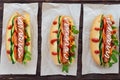 Home made hot dogs with vegetables, juicy sausage and arugula Royalty Free Stock Photo