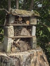 Home made insect hotel decorative bug house from sandstone and wood, ladybird and bee home for butterfly hibernation and Royalty Free Stock Photo