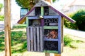 Home made insect wooden house or bug hotel ladybird bee home for garden to help butterfly hibernation and ecological gardening Royalty Free Stock Photo