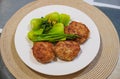 Home made minced meat cutlets served with green vegetables. Healthy food. Meatballs on a white plate with veggies Royalty Free Stock Photo