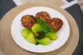 Home made minced meat cutlets served with green vegetables. Healthy food. Meatballs on a white plate with veggies Royalty Free Stock Photo