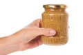 Home made mustard in glass bottle in hand isolated on white background Royalty Free Stock Photo