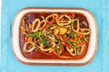 Home-made noodles stewed with green and red peppers, vegetables, squid rings, beef. Royalty Free Stock Photo