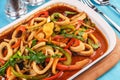 Home-made noodles stewed with green and red peppers, vegetables, squid rings, beef. Royalty Free Stock Photo