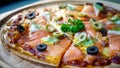 Home made pizza with salmon and olives