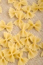 Home made raw farfalle on jute