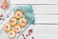 Home made rose short bread cookies on white wooden table top with copy space for text