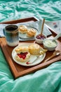 Home made scones with strawberry jam  clotted cream served in bed. Royalty Free Stock Photo