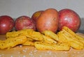 Home Made Style Chips  With Raw Potaoes In The Background Royalty Free Stock Photo