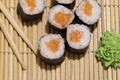 Home made sushi rolls maki with raw salmon fish on tradition carpet with wooden sticks and wasabi Royalty Free Stock Photo