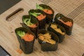 Home made sushi sitting on cutting board Royalty Free Stock Photo