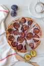 Home made sweet rustic plum cake on a table