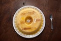 home made vanilla and cinnamon flan over a wooden table